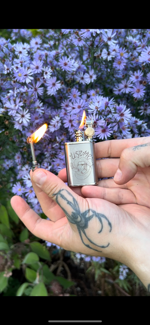 'Use me' fuel lighter with reusable flint match